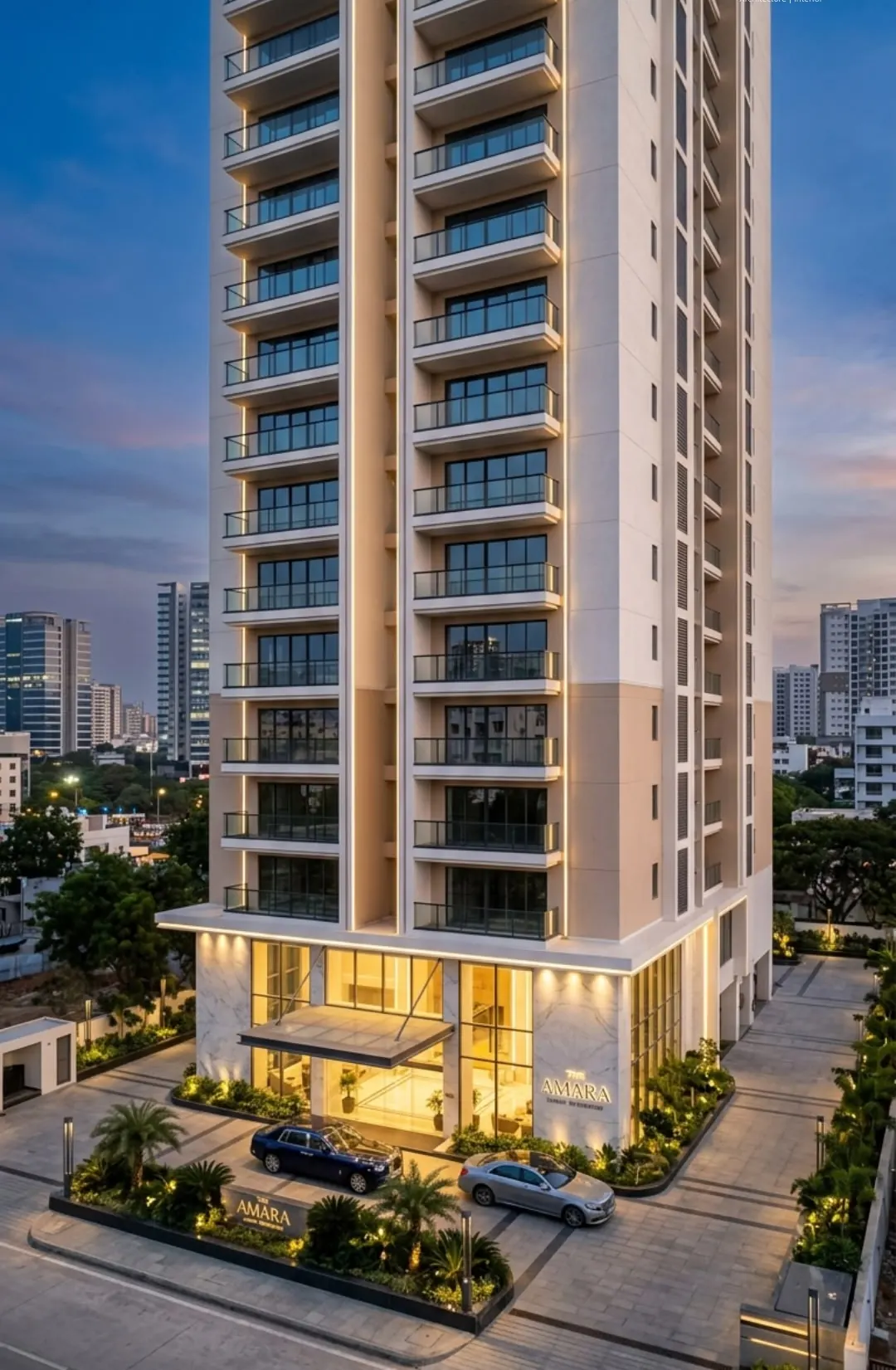 Tall residential tower with a lit lobby and landscaped drop-off