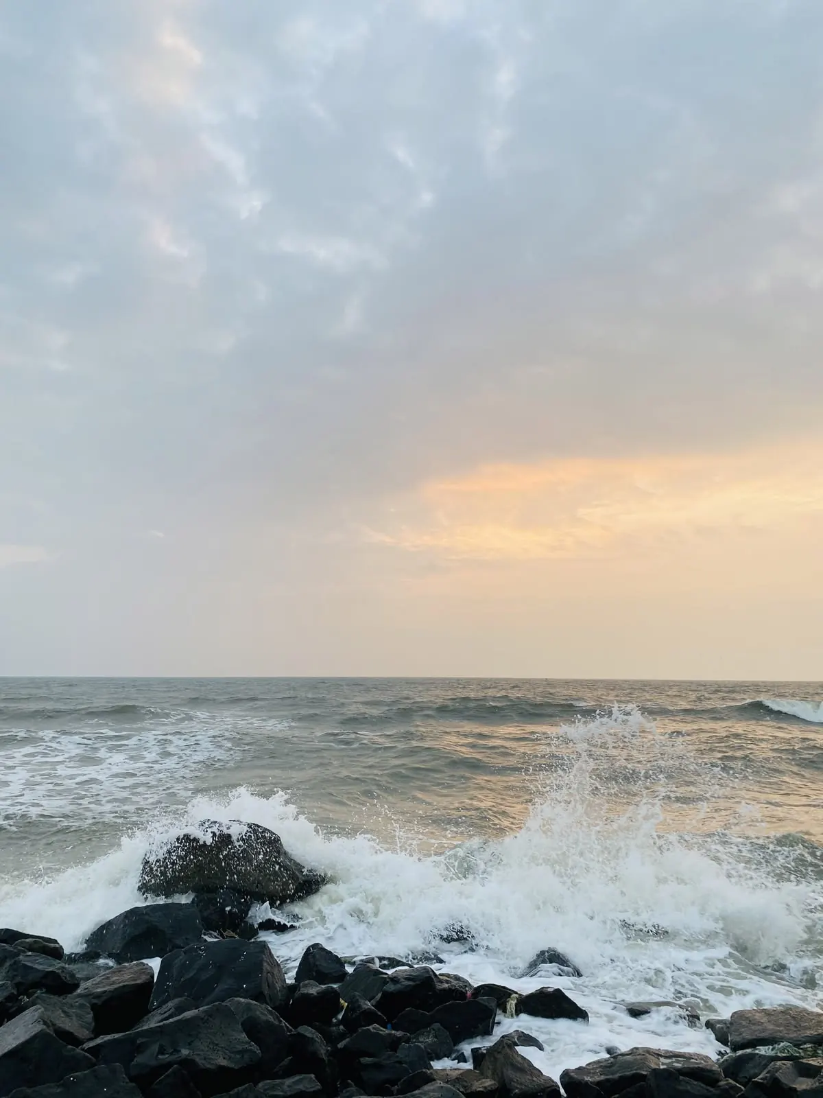 Waves breaking on rocks along the East Coast Road shoreline